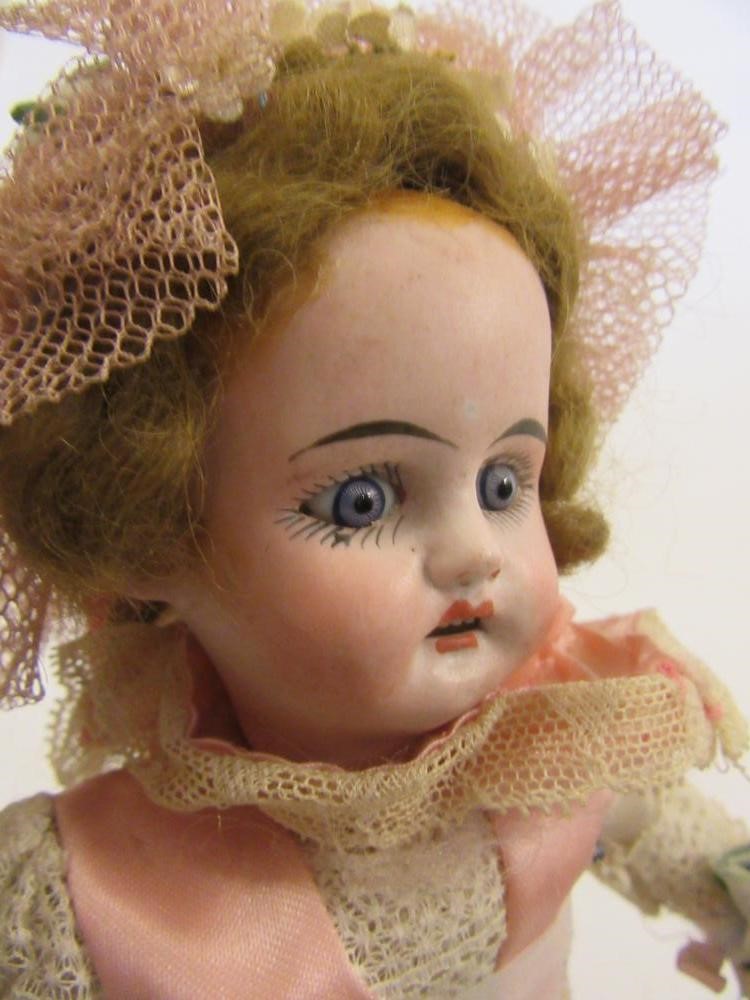 A Sonneberger Porcellanfabrik bisque head doll with fixed blue glass eyes Image