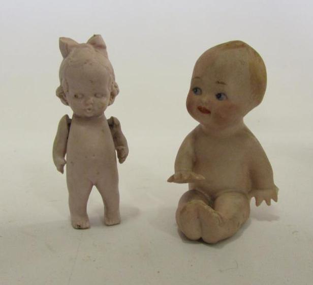 An all bisque seated "Frozen Charlie" with painted face and moulded hair Image