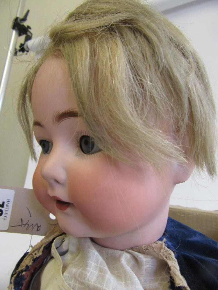 An Ernst Heubach bisque head character doll with blue glass sleeping eyes Image