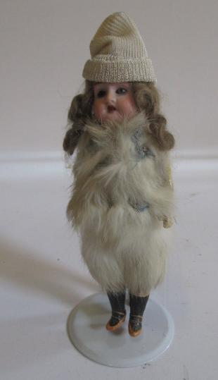 A Theodor Recknagel bisque head doll with fixed blue glass eyes Image