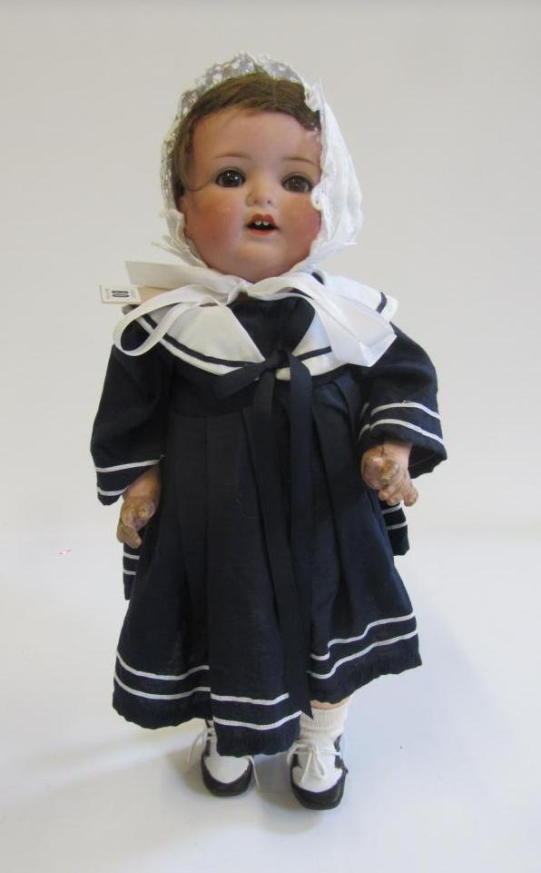 An Armand Marseille bisque head character doll with brown glass sleeping eyes Image