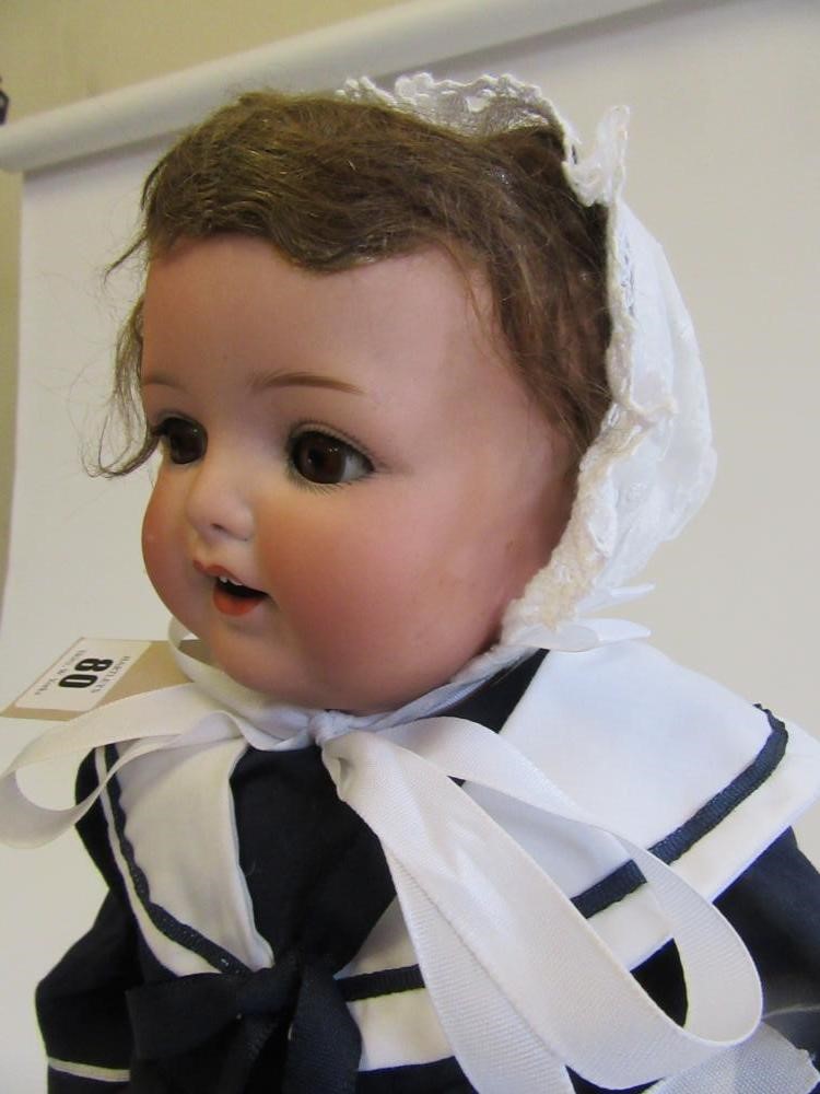 An Armand Marseille bisque head character doll with brown glass sleeping eyes Image