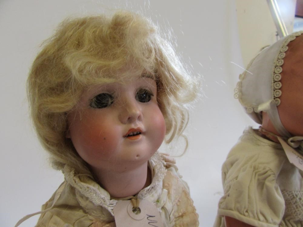 A German bisque head doll with brown glass sleeping eyes Image