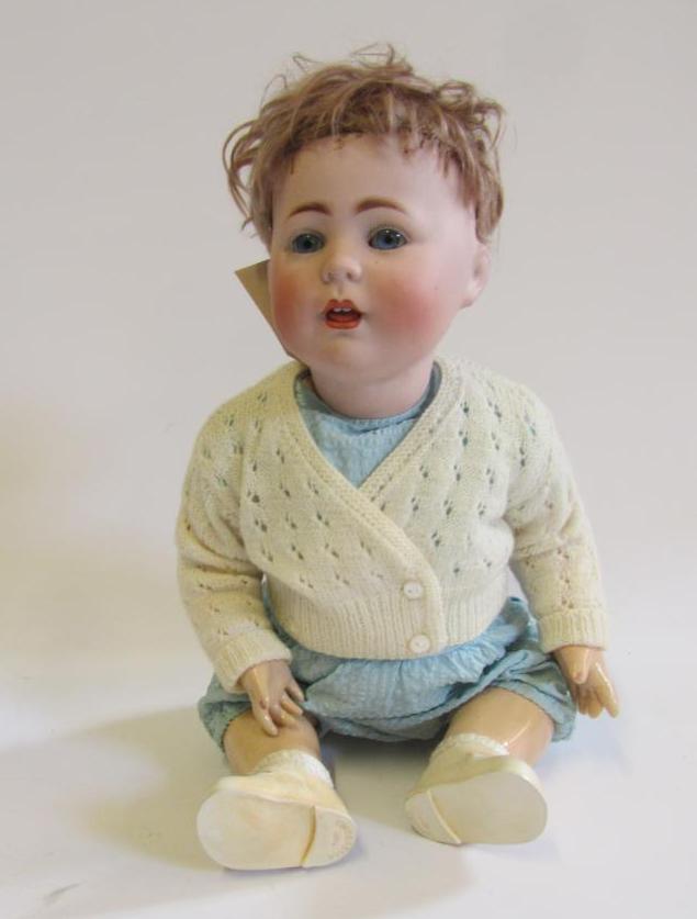 A Cuno & Otto Dressel bisque head doll with blue glass fixed eyes Image