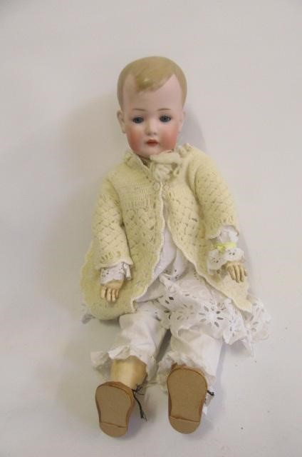 A Bruno Schmidt bisque head boy doll with blue glass sleeping eyes Image