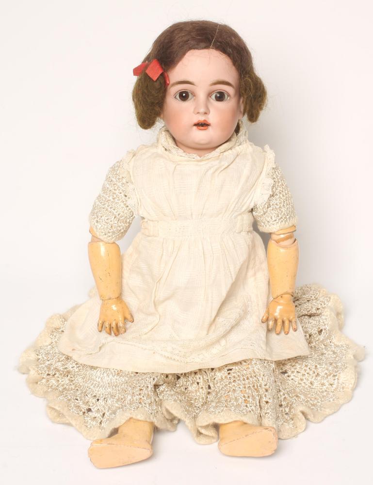A Kestner bisque head doll with blue glass sleeping eyes Image