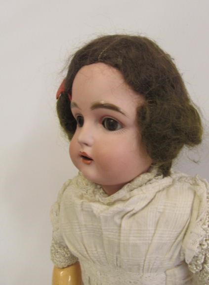 A Kestner bisque head doll with blue glass sleeping eyes Image