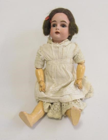 A Kestner bisque head doll with blue glass sleeping eyes Image