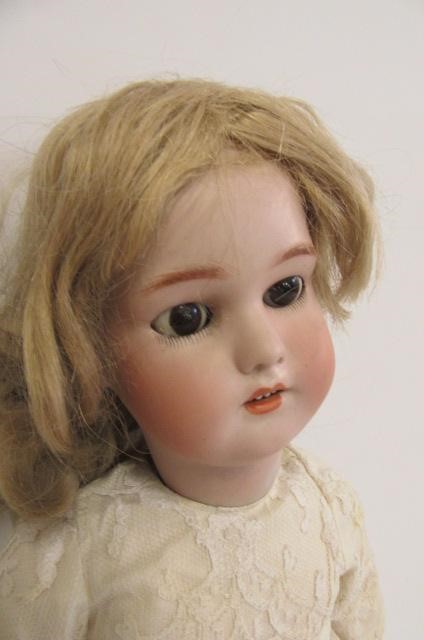 A Simon & Halbig bisque head doll with brown glass sleeping eyes Image
