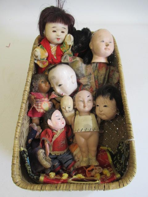 A basket of vintage oriental dolls Image