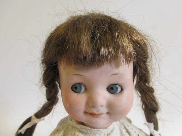 An Armand Marseille Googly eye doll, with blue glass fixed eyes, closed mouth, bent limb composition Image