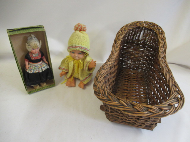 Wicker dolls crib, together with a boxed Dovina Dutch doll and a vintage baby (3) (Est. plus 24% Image