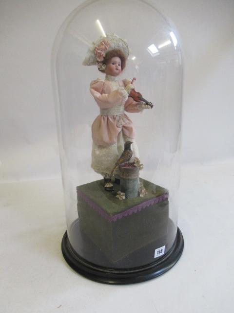 A bisque head automaton doll under dome Image