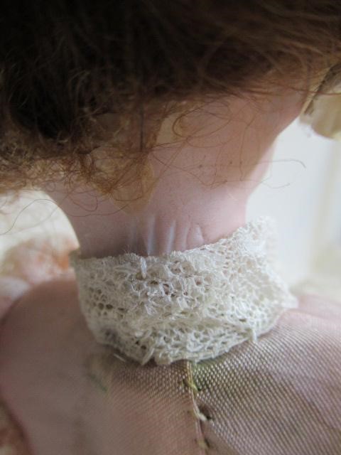 A bisque head automaton doll under dome Image