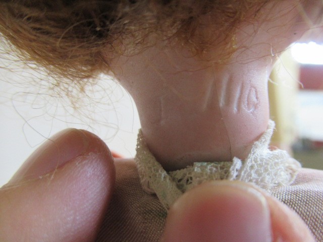 A bisque head automaton doll under dome Image