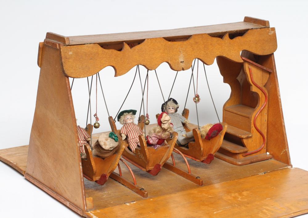An early 20th century musical doll's swing boat set ensuite with six French dolls Image