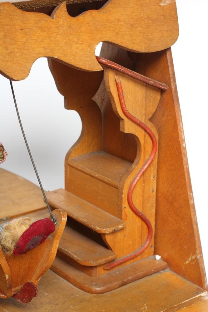 An early 20th century musical doll's swing boat set ensuite with six French dolls Image