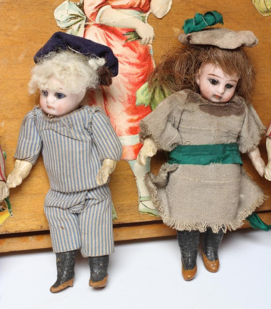 An early 20th century musical doll's swing boat set ensuite with six French dolls Image