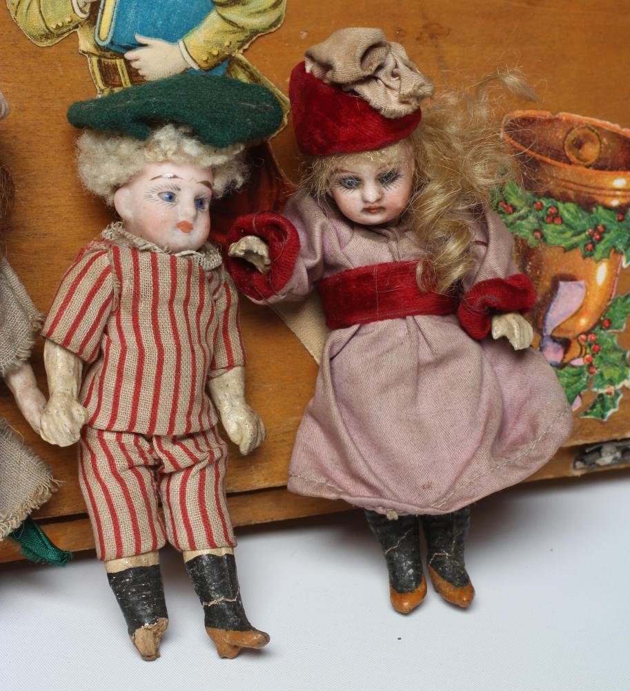 An early 20th century musical doll's swing boat set ensuite with six French dolls Image