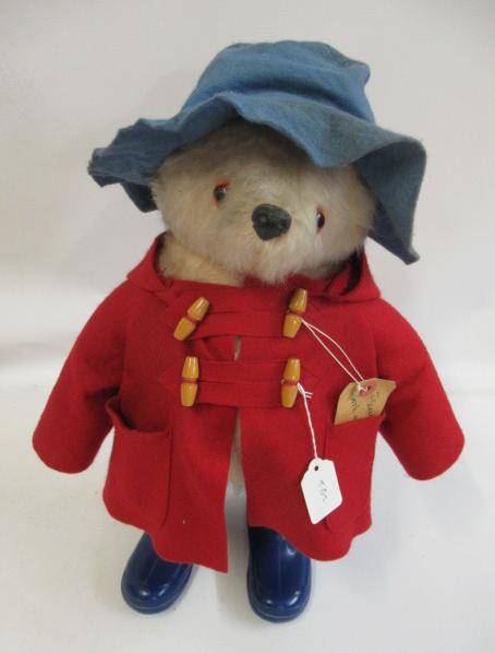 Paddington bear, with blue felt hat, red coat, label and original blue boots (Est. plus 24% premium Image