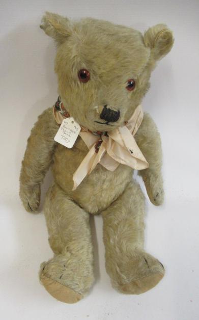 A mid war English teddy bear, with yellow plush, amber glass eyes and cloth pads, 21" long (Est. Image