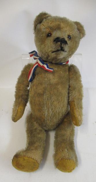 An American type pre-war teddy bear, with glass amber eyes, sewn nose, light brown plush and felt Image