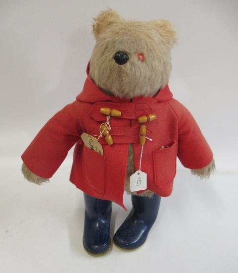 Paddington bear, with red felt coat, label and blue dunlop boots (Est. plus 24% premium inc. VAT) Image