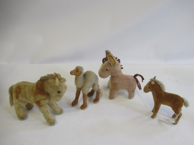 Four mid century Steiff items, comprising a Kamel, a Fohlen with silver button, a horse and a donkey Image