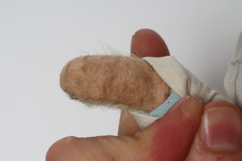 A rare pre-war white teddy bear, with amber glass eyes, sewn nose, white plush, straw filling, felt Image