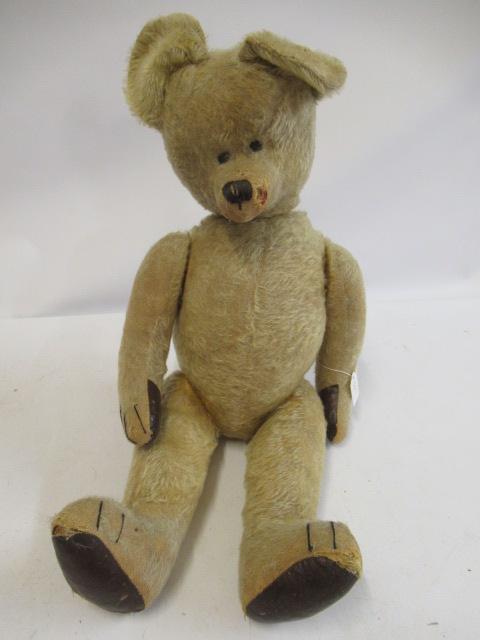 A large mid-war teddy bear, with sewn eyes, sewn nose, blond plush, straw filling and leatherette Image