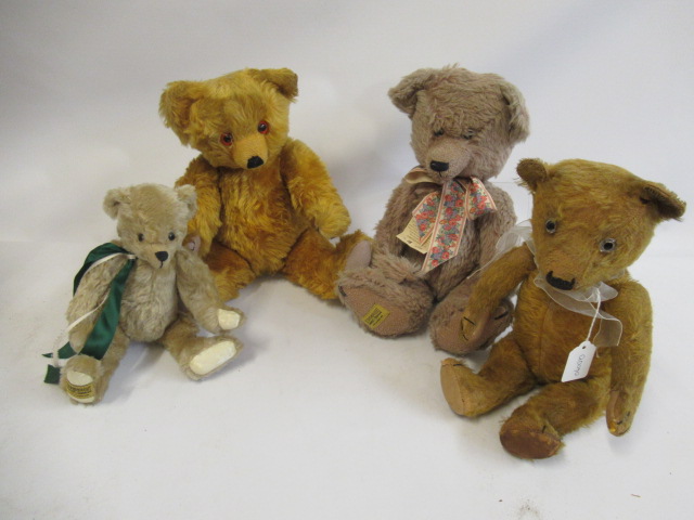 Four teddy bears, comprising a vintage straw filled teddy with clear glass eyes, orange plush and Image