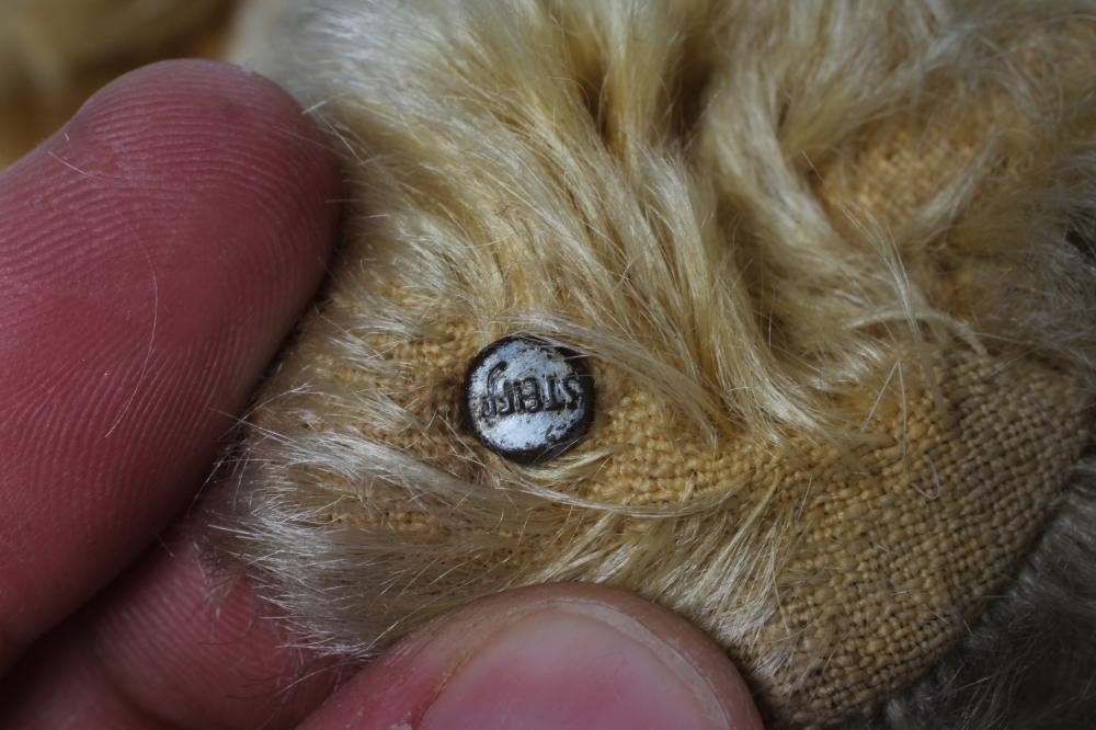 An early Steiff teddy bear, with amber glass eyes, sewn nose, felt pads, orange plush and button to Image