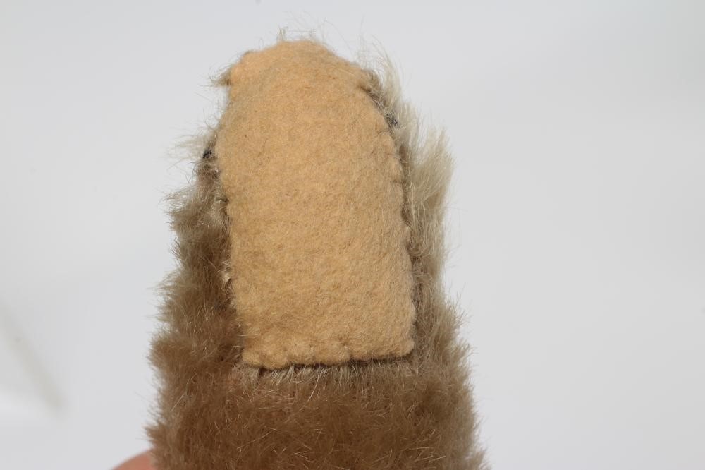 An old Steiff teddy bear, with black button eyes, sewn nose, replaced felt pads, light orange plush Image