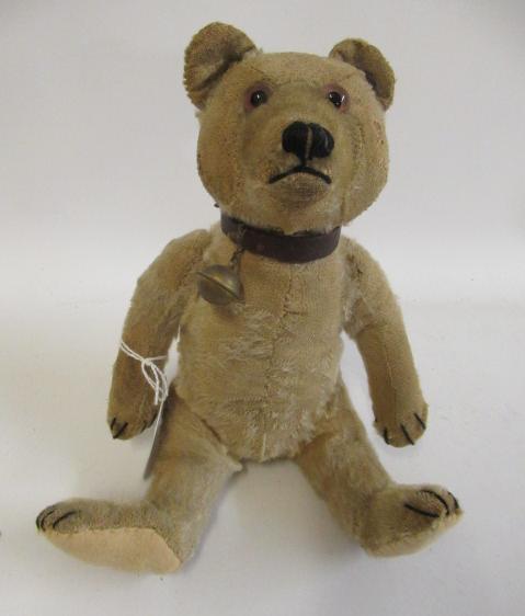 An old Steiff teddy bear, with glass eyes, later sewn nose, light plush, felt pads and leather Image