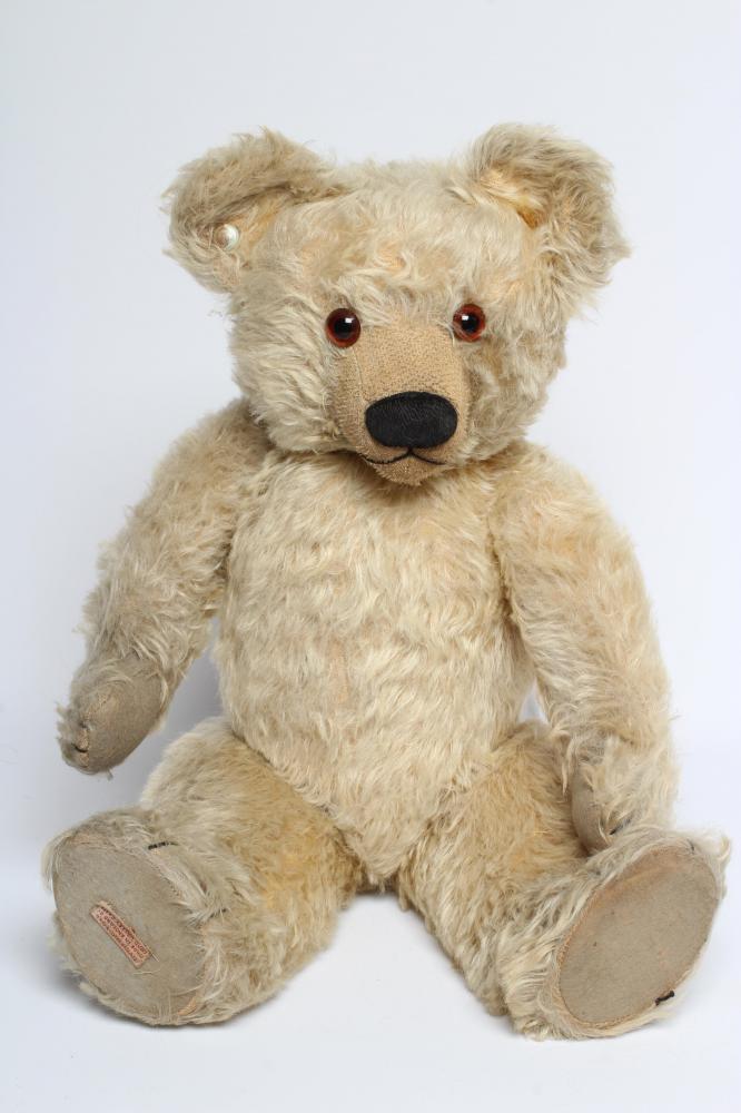 A Chad Valley teddy bear, with amber eyes, sewn nose, felt pads, light orange plush and Hygienic Image