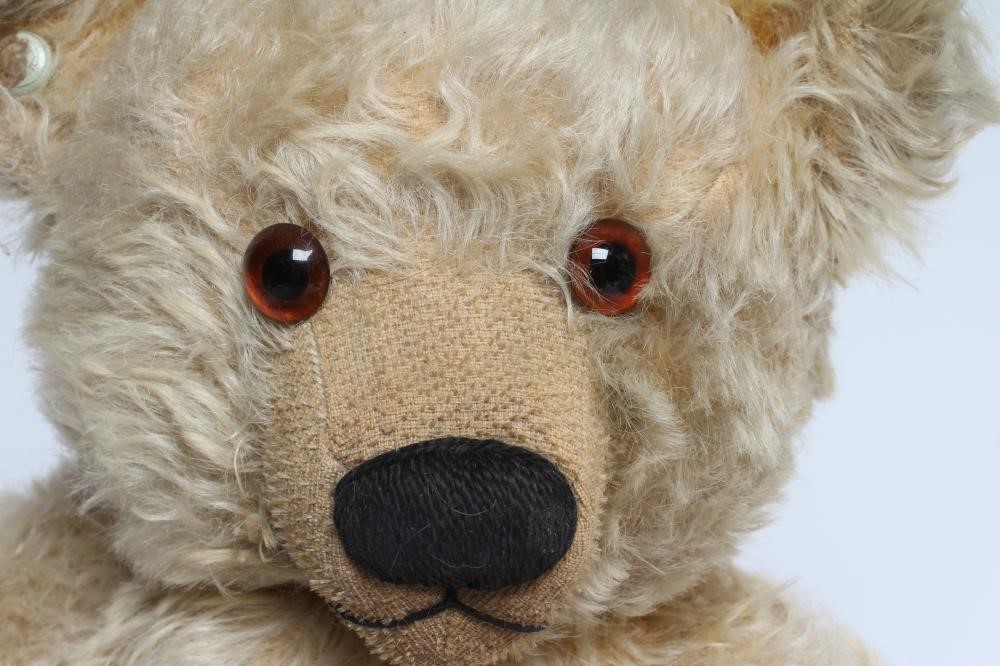 A Chad Valley teddy bear, with amber eyes, sewn nose, felt pads, light orange plush and Hygienic Image