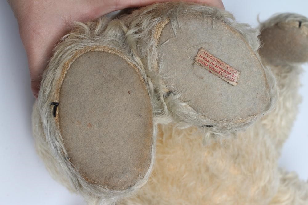 A Chad Valley teddy bear, with amber eyes, sewn nose, felt pads, light orange plush and Hygienic Image