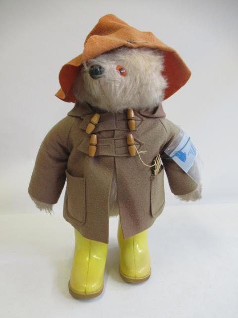 A Gabrielle Designs Paddington Bear, with amber eyes, orange felt hat, brown jacket, yellow Dunlop Image
