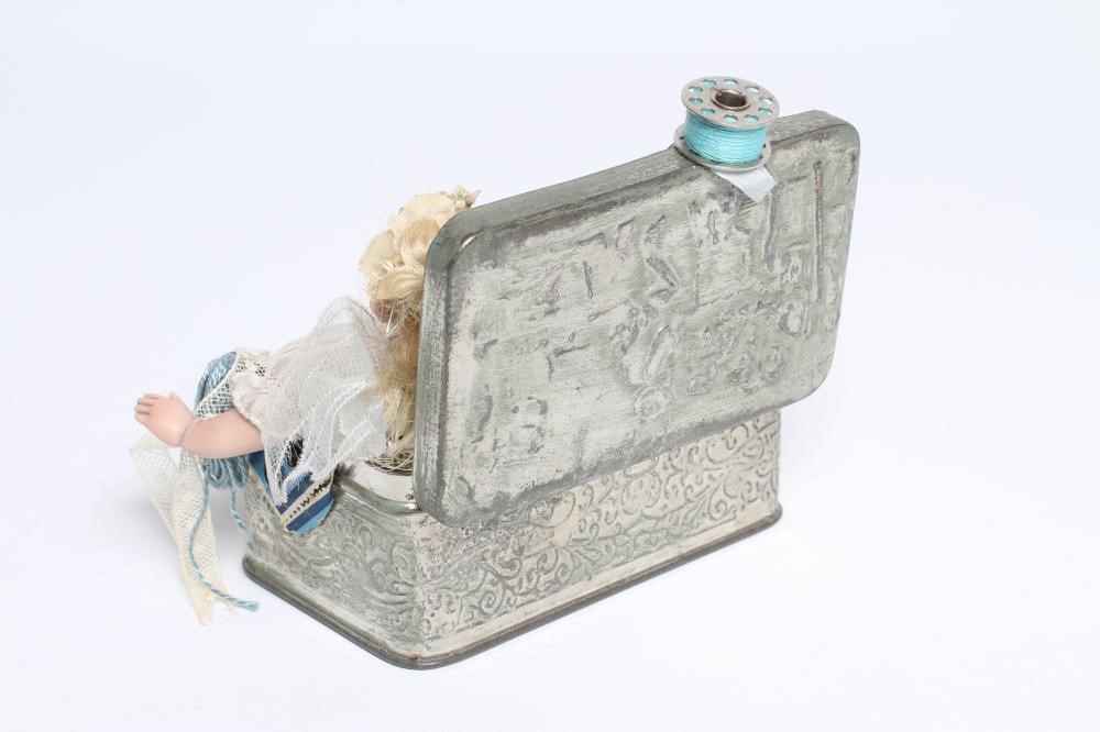 A Gerda Schaarman doll display, depicting a fairy with bisque head and limbs, sat within a Image