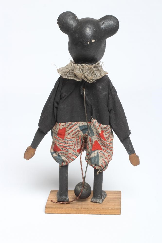 An early Mickey Mouse figure, with composition head, wooden body, original clothing, string tail and Image