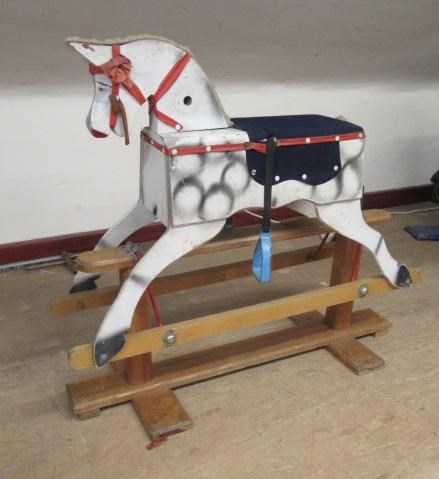 A vintage rocking horse, of wood box construction, with dappled grey paint, fabric saddle and swung Image