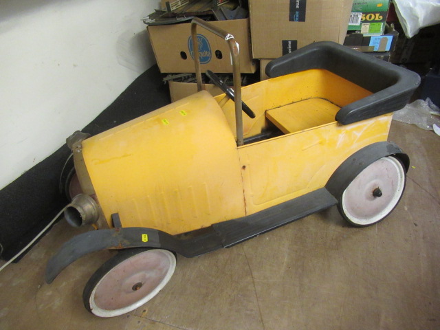 A vintage brum pedal car of metal construction with classic yellow body paint forward crank Hartleys Auctioneers Valuers