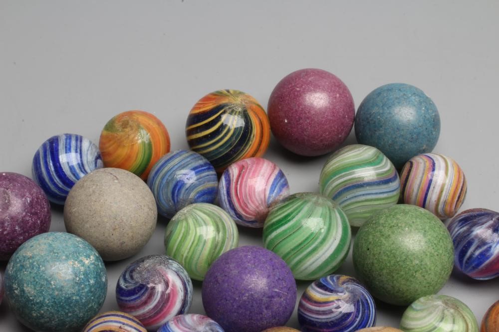 Fifty two early glass and clay marbles from 10-15mm sizes, most items in good condition (Est. plus Image