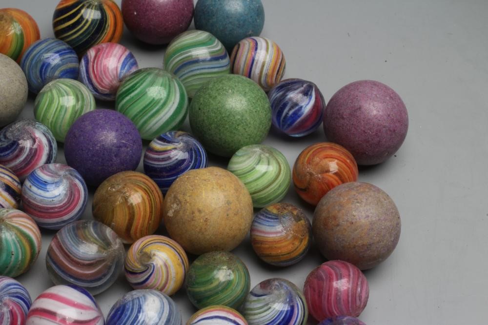 Fifty two early glass and clay marbles from 10-15mm sizes, most items in good condition (Est. plus Image
