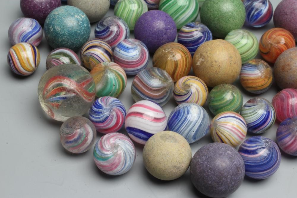 Fifty two early glass and clay marbles from 10-15mm sizes, most items in good condition (Est. plus Image