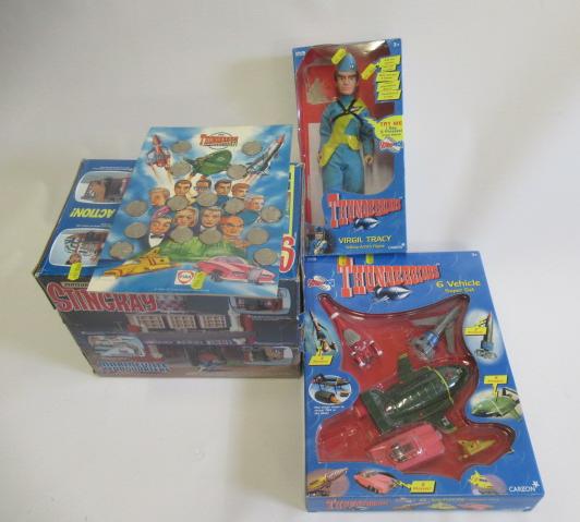Carlton Thunderbirds vehicle set, Virgil Tracy doll and Coin Collector board, together with a Image