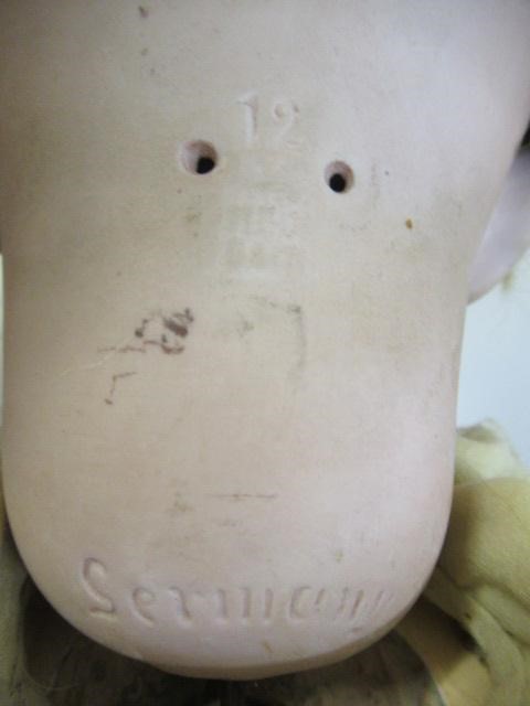 A Heubach bisque socket head boy doll Image