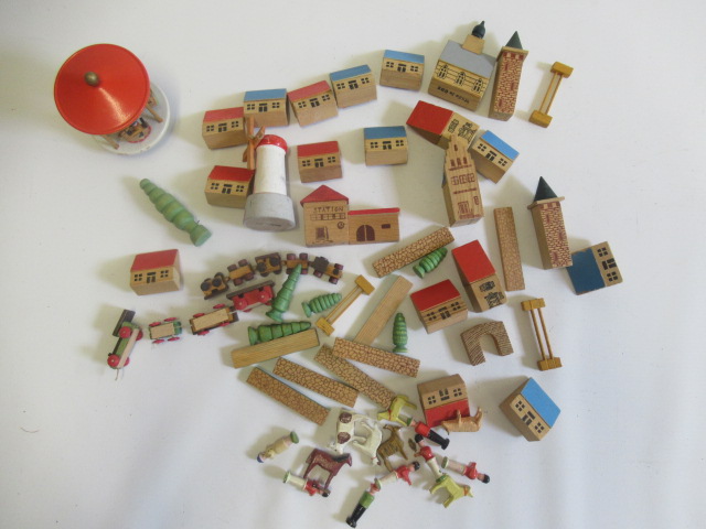 Wooden buildings, trains and figures by a German manufacturer, most items in good order, marked Made Image