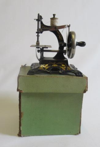 Miniature hand operated sewing machine with cast iron base marked Made in Germany, box AF, G-E (Est. Image