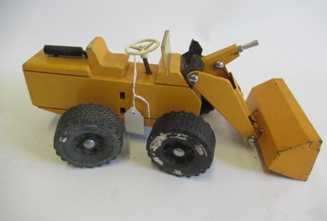 A Steiff wood and metal yellow digger, rubber tyres with operating steering and shovel, F-G (Est. Image